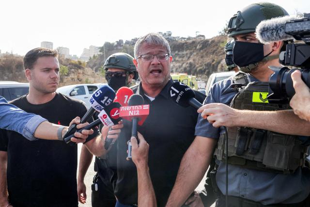 Itamar Ben Gvir (C), Israel's national security minister and head of the far-right Otzma Yehudit (Jewish Power) party, speaks to the media at the scene following a fire exchange between armed Palestinians and Israeli forces at the northern checkpoint of Hebron in the Israeli-occupied West Bank on October 23, 2026. Israeli troops on October 23 shot dead two suspected Palestinian assailants in the West Bank after a shooting that left at least five people wounded, officials said. (Photo by AHMAD GHARABLI / AFP)