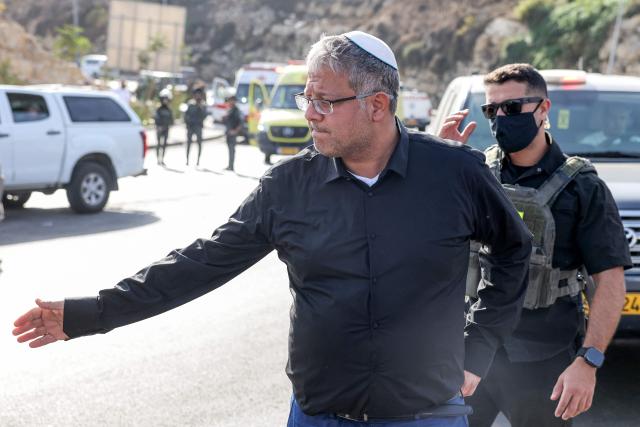 Itamar Ben Gvir, Israel's national security minister and head of the far-right Otzma Yehudit (Jewish Power) party, meets people at the scene following a fire exchange between armed Palestinians and Israeli forces at the northern checkpoint of Hebron in the Israeli-occupied West Bank on October 23, 2026. Israeli troops on October 23 shot dead two suspected Palestinian assailants in the West Bank after a shooting that left at least five people wounded, officials said. (Photo by AHMAD GHARABLI / AFP)