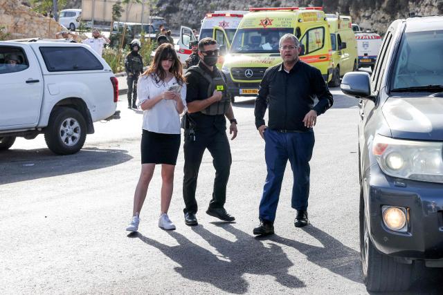 Itamar Ben Gvir (R), Israel's national security minister and head of the far-right Otzma Yehudit (Jewish Power) party, arrives at the scene following a fire exchange between armed Palestinians and Israeli forces at the northern checkpoint of Hebron in the Israeli-occupied West Bank on October 23, 2026. Israeli troops on October 23 shot dead two suspected Palestinian assailants in the West Bank after a shooting that left at least five people wounded, officials said. (Photo by AHMAD GHARABLI / AFP)