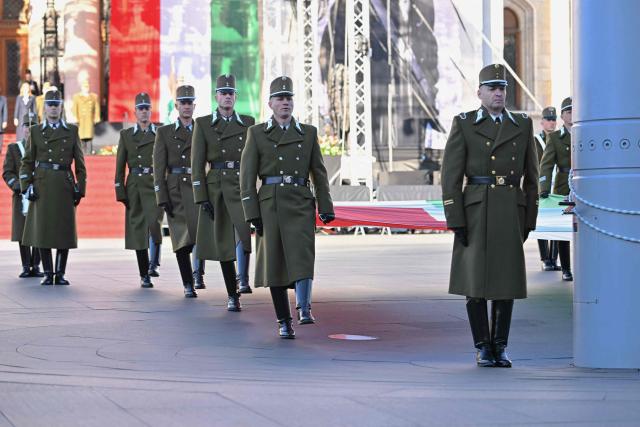 Soldiers of a Hungarian honor guard march at Kossuth square in front of the Hungarian Parliament building in Budapest on October 23, 2026 during a flag-hosting ceremony to mark the 70th anniversary of the Hungarian Revolution of 1956, also known as the Hungarian Uprising against the Soviet communist regime. (Photo by Attila KISBENEDEK / AFP)