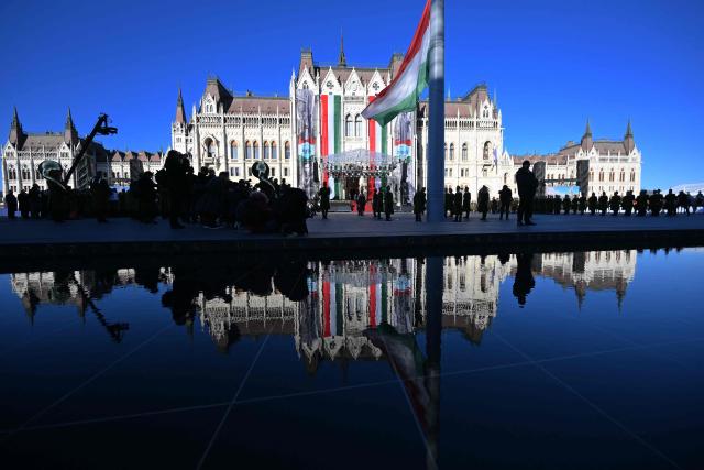 The Hungarian parliament reflects in a water surface at Kossuth square in front of the Hungarian Parliament building in Budapest on October 23, 2026 during a flag-hosting ceremony to mark the 70th anniversary of the Hungarian Revolution of 1956, also known as the Hungarian Uprising against the Soviet communist regime. (Photo by Attila KISBENEDEK / AFP)