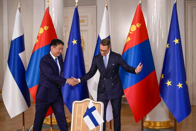 Mongolia's President Ukhnaagiin Khurelsukh (L) is welcomed by Finland's President Alexander Stubb during the visit of the President of Mongolia at the Presidential Palace in Helsinki, Finland on October 23, 2026. (Photo by Markku Ulander / Lehtikuva / AFP) / Finland OUT