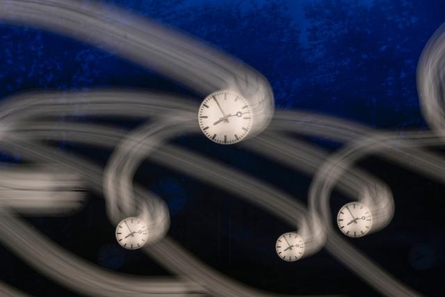 A long-exposure photograph shows clocks of the art installation 'Zeitfeld' (time field) by German artist Klaus Rinke in Duesseldorf, western Germany, on October 23, 2026. Daylight Saving Time will end on October 25, 2026, and clocks will be turned one hour backward for winter time. (Photo by Ina FASSBENDER / AFP)