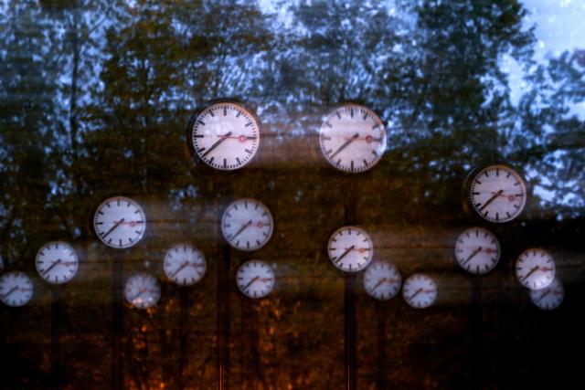 A long-exposure photograph shows clocks of the art installation 'Zeitfeld' (time field) by German artist Klaus Rinke in Duesseldorf, western Germany, on October 23, 2026. Daylight Saving Time will end on October 25, 2026, and clocks will be turned one hour backward for winter time. (Photo by Ina FASSBENDER / AFP)