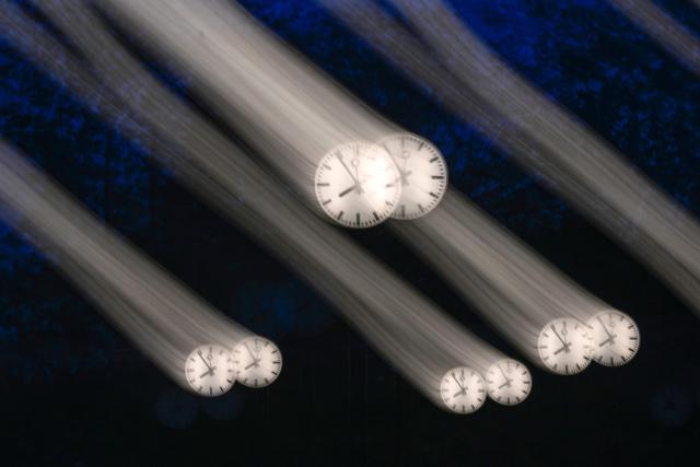 A long-exposure photograph shows clocks of the art installation 'Zeitfeld' (time field) by German artist Klaus Rinke in Duesseldorf, western Germany, on October 23, 2026. Daylight Saving Time will end on October 25, 2026, and clocks will be turned one hour backward for winter time. (Photo by Ina FASSBENDER / AFP)