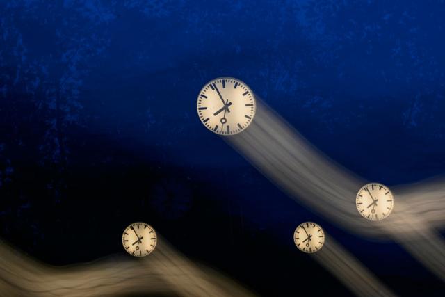 A long-exposure photograph shows clocks of the art installation 'Zeitfeld' (time field) by German artist Klaus Rinke in Duesseldorf, western Germany, on October 23, 2026. Daylight Saving Time will end on October 25, 2026, and clocks will be turned one hour backward for winter time. (Photo by Ina FASSBENDER / AFP)