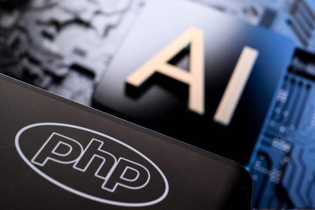 An illustration picture taken on October 23, 2026 shows the PHP (Hypertext Preprocessor) logo on a smartphone screen and the AI letters on a laptop screen in Frankfurt am Main, western Germany. Government agencies and companies around the world shut down websites on October 21, 2026 after two critical flaws came to light involving PHP, a programming language that is the basis for a large share of the internet. (Photo by Kirill KUDRYAVTSEV / AFP)