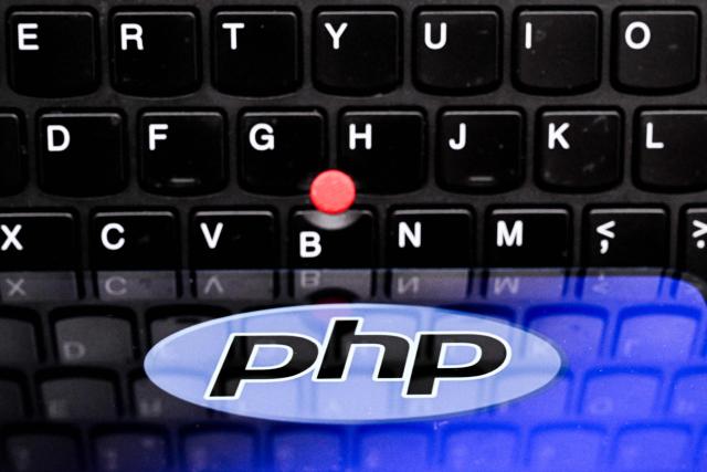 An illustration picture taken on October 23, 2026 shows the PHP (Hypertext Preprocessor) logo on a smartphone screen in front of laptop keyboard in Frankfurt am Main, western Germany. Government agencies and companies around the world shut down websites on October 21, 2026 after two critical flaws came to light involving PHP, a programming language that is the basis for a large share of the internet. (Photo by Kirill KUDRYAVTSEV / AFP)