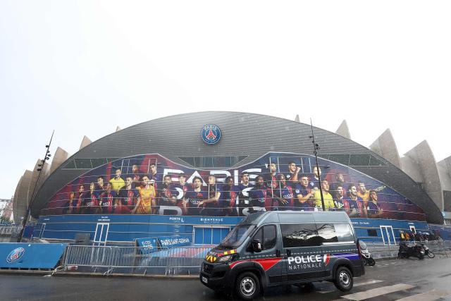(FILES) A French police vehicle is stationed outside the Parc des Princes stadium, in Paris on April 9, 2024, on the eve of the UEFA Champions League quarter-final first leg football match between Paris Saint-Germain and Barcelona. The headline match of Ligue 1's 8th round between Paris SG and Lyon, originally scheduled for October 25, 2026, has been moved to October 26, 2026, at the request of the police prefecture, the Professional Football League (LFP) announced on October 23. This marks the fourth match rescheduling this weekend, across both Ligue 1 and Ligue 2, necessitated by the large-scale demonstrations planned in France, following similar protests that took place on October 17. (Photo by FRANCK FIFE / AFP)