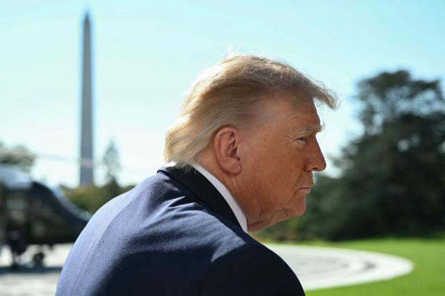 US President Donald Trump speaks to the media before boarding Marine One on the South Lawn of the White House in Washington, DC, on October 23, 2026. President Trump is travelling to Florida to speak at a midterm campaign rally. (Photo by Alex WROBLEWSKI / AFP)