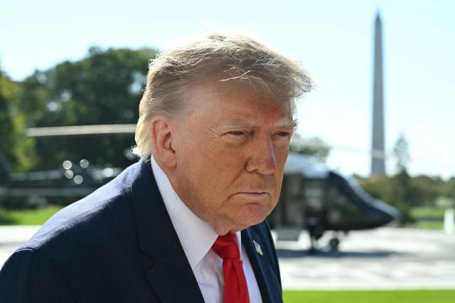 US President Donald Trump speaks to the media before boarding Marine One on the South Lawn of the White House in Washington, DC, on October 23, 2026. President Trump is travelling to Florida to speak at a midterm campaign rally. (Photo by Alex WROBLEWSKI / AFP)