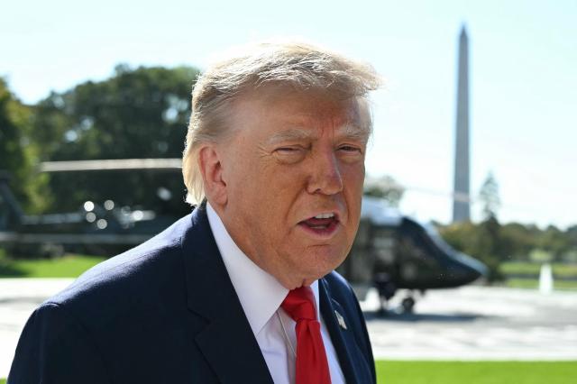 US President Donald Trump speaks to the media before boarding Marine One on the South Lawn of the White House in Washington, DC, on October 23, 2026. President Trump is travelling to Florida to speak at a midterm campaign rally. (Photo by Alex WROBLEWSKI / AFP)