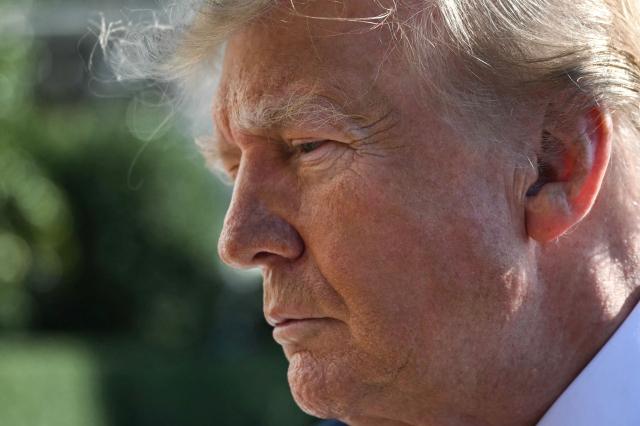 US President Donald Trump speaks to the media before boarding Marine One on the South Lawn of the White House in Washington, DC, on October 23, 2026. President Trump is travelling to Florida to speak at a midterm campaign rally. (Photo by Alex WROBLEWSKI / AFP)
