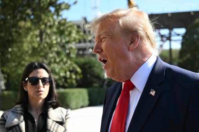 US President Donald Trump speaks to the media before boarding Marine One on the South Lawn of the White House in Washington, DC, on October 23, 2026. President Trump is travelling to Florida to speak at a midterm campaign rally. (Photo by Alex WROBLEWSKI / AFP)