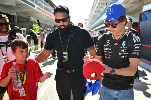 Mercedes' Italian driver Kimi Antonelli signs autograph for a fan as he arrives ahead of the practice session for the United States Formula One Grand Prix at the Circuit of the Americas in Austin, Texas, on October 23, 2026. (Photo by ANGELA WEISS / AFP)