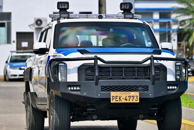 A National Police vehicle stands guard outside the Modelo Police Headquarters, where former presidential candidate Luisa Gonzalez is being held, in Guayaquil, Ecuador, on October 23, 2026. Ecuadorian police arrested former left-wing presidential candidate Luisa Gonzalez on October 22, 2026, over alleged money laundering during the 2023 election campaign that brought current President Daniel Noboa to power. (Photo by MARCOS PIN / AFP)