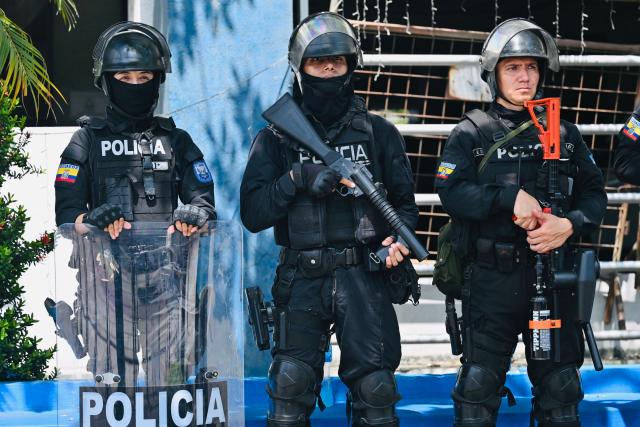 National Police officers stand guard outside the Modelo Police Headquarters, where former presidential candidate Luisa Gonzalez is being held, in Guayaquil, Ecuador, on October 23, 2026. Ecuadorian police arrested former left-wing presidential candidate Luisa Gonzalez on October 22, 2026, over alleged money laundering during the 2023 election campaign that brought current President Daniel Noboa to power. (Photo by MARCOS PIN / AFP)