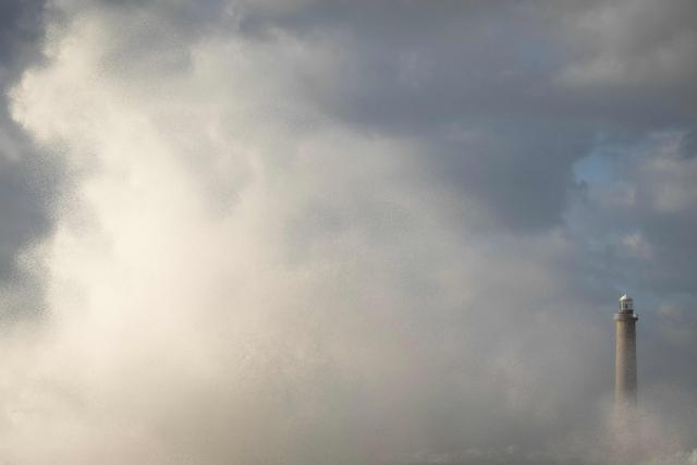 This photograph shows the Goury Lighthouse off La Hague, northwestern France, on October 23, 2026, as the storm Austen hits the coasts of France. (Photo by Guillaume SALIGOT / AFP)