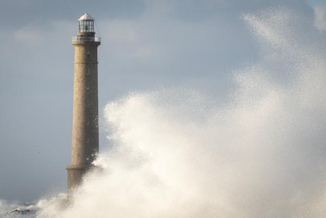 This photograph shows the Goury Lighthouse off La Hague, northwestern France, on October 23, 2026, as the storm Austen hits the coasts of France. (Photo by Guillaume SALIGOT / AFP)