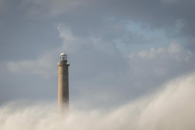 This photograph shows the Goury Lighthouse off La Hague, northwestern France, on October 23, 2026, as the storm Austen hits the coasts of France. (Photo by Guillaume SALIGOT / AFP)