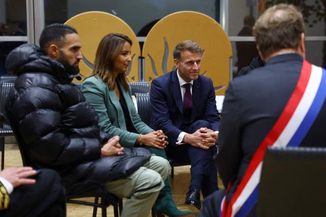 France's President Emmanuel Macron meets with community members at the town hall following a shooting in Trappes, near Paris on October 23, 2026. The National Anti-Terrorism Prosecutor’s Office (Pnat) has announced that it is taking up the case of a man who fired bursts of shots from his car on October 23, morning in the street in Trappes (Yvelines), killing one person and injuring at least four others. (Photo by Hannah McKay / POOL / AFP)