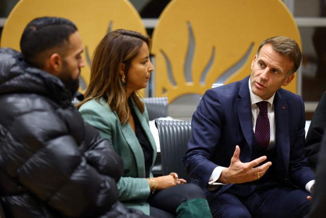 France's President Emmanuel Macron meets with community members at the town hall following a shooting in Trappes, near Paris on October 23, 2026. The National Anti-Terrorism Prosecutor’s Office (Pnat) has announced that it is taking up the case of a man who fired bursts of shots from his car on October 23, morning in the street in Trappes (Yvelines), killing one person and injuring at least four others. (Photo by Hannah McKay / POOL / AFP)