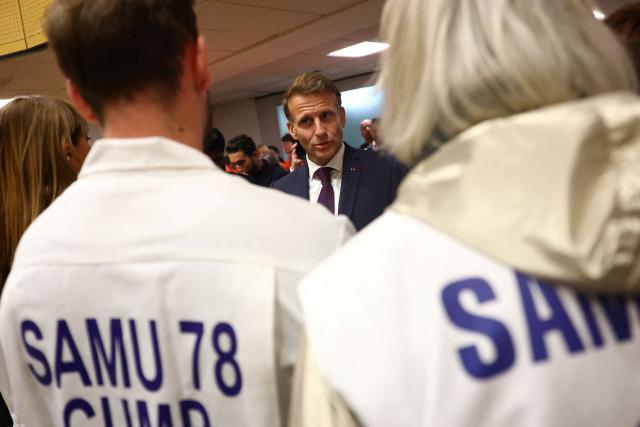 France's President Emmanuel Macron meets with rescue forces at the town hall following a shooting in Trappes, near Paris on October 23, 2026. The National Anti-Terrorism Prosecutor’s Office (Pnat) has announced that it is taking up the case of a man who fired bursts of shots from his car on October 23, morning in the street in Trappes (Yvelines), killing one person and injuring at least four others. (Photo by Hannah McKay / POOL / AFP)