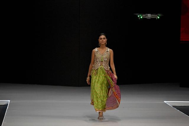A model presents a creation of Sania Maskatiya during the LAAM Fashion Week in Lahore on October 23, 2026. (Photo by Arif ALI / AFP)