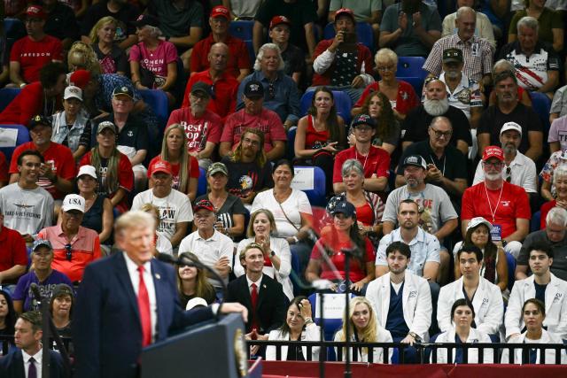 Attendees listen as US President Donald Trump speaks during a campaign rally at the Alico Arena, Florida Gulf Coast University in Fort Myers, Florida on October 23, 2026. (Photo by Brendan SMIALOWSKI / AFP)