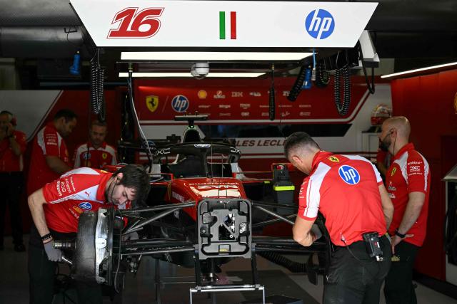 Ferrari technicians work on the car of Ferrari's Monegasque driver Charles Leclerc in the garage before the second practice session for the United States Formula One Grand Prix at the Circuit of the Americas in Austin, Texas, on October 23, 2026. (Photo by RONALDO SCHEMIDT / AFP)