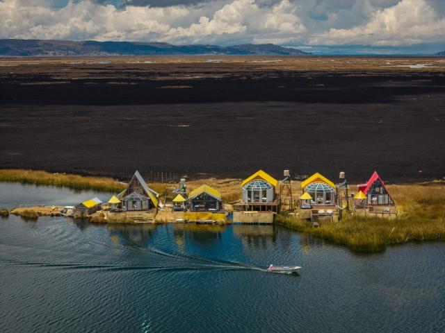 This aerial view shows a huge blackened area in the Lake Titicaca National Reserve near the floating islands of the Uros in Puno, Peru, on October 23, 2026, following a fire that ravaged around 400 hectares of totora reeds on October 21. Forest fires fueled by El Nino have killed 12 people and left hundreds homeless in Peru since June, authorities in the Andean country said on October 21. (Photo by URIEL MONTEFUR / AFP)
