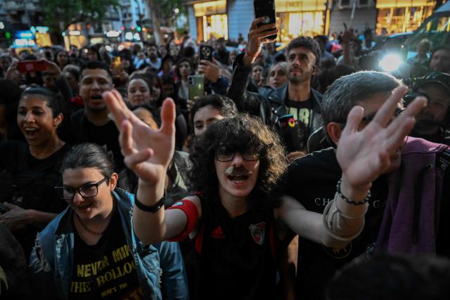 Fans of Argentina's music icon Charly Garcia gather outside his residence to celebrate his 75th birthday in Buenos Aires on October 23, 2026. (Photo by Luis ROBAYO / AFP)