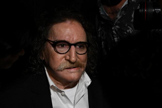 Argentina's music icon Charly Garcia greets fans outside his residence to celebrate his 75th birthday in Buenos Aires on October 23, 2026. (Photo by Luis ROBAYO / AFP)