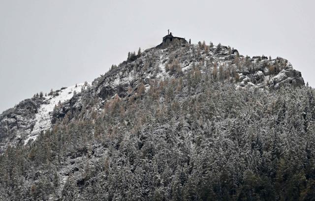 View taken on October 24, 2026 shows the mountain guesthouse Kehlsteinhaus (top), known as the Eagle's Nest, formerly Adolf Hitler's mountain retreat, after a large fire had broken out at the site located at an altitude of 1,834 metres (6,000 feet) in the mountains over Berchtesgaden, in the southern German state of Bavaria. Emergency services arrived on site on late October 23, 2026 and found a large fire. German police said on October 24, 2026 they have detained a suspect following a fire at Adolf Hitler's mountain retreat, known as the Eagle's Nest. (Photo by KERSTIN JOENSSON / AFP)