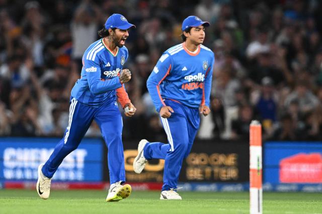India's Tilak Varma (L) celebrates after taking the catch to dismiss New Zealand's Tim Seifert during the second Twenty20 international cricket match between New Zealand and India at Hagley Oval in Christchurch on October 24, 2026. (Photo by Sanka VIDANAGAMA / AFP)
