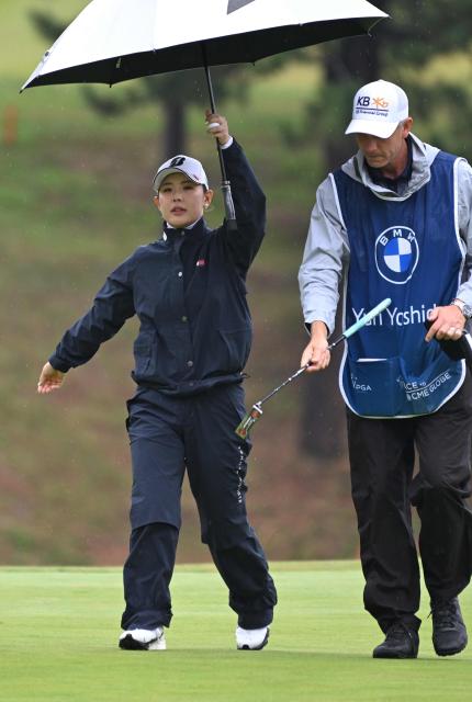 Yuri Yoshida of Japan walks under her umbrella with her caddie on the 5th green during the third round of the LPGA Tour - BMW Ladies Championship golf tournament at Pine Beach Golf Links in Haenam on October 24, 2026. (Photo by Jung Yeon-je / AFP)
