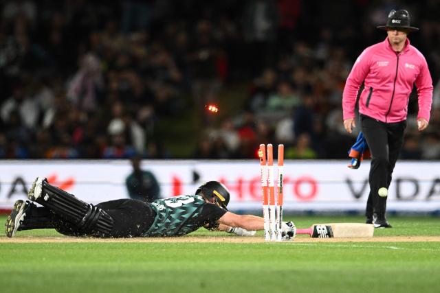 New Zealand's Glenn Phillips dives to secure a run during the second Twenty20 international cricket match between New Zealand and India at Hagley Oval in Christchurch on October 24, 2026. (Photo by Sanka VIDANAGAMA / AFP)