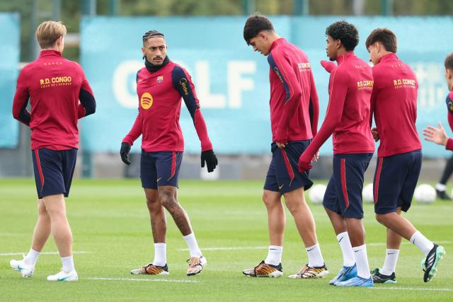 Barcelona's Brazilian forward #11 Raphinha (2L) talks to Barcelona's Spanish forward #10 Lamine Yamal (2R) during a training session on the eve of their Spanish league "Clasico" football match against Real Madrid CF at the Joan Gamper training ground in Sant Joan Despi, near Barcelona, on October 24, 2026 (Photo by Lluis GENE / AFP)