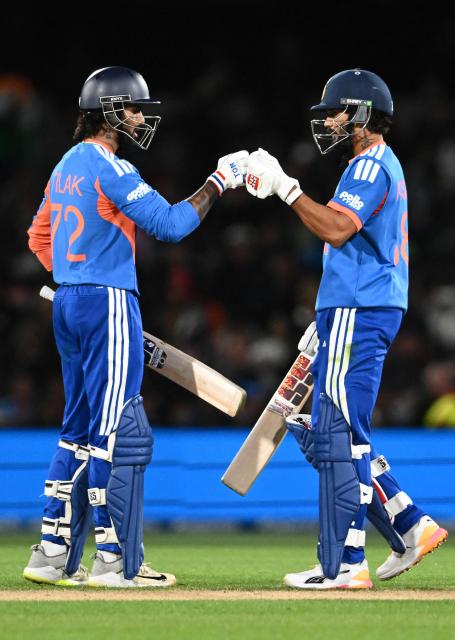 India's Nitish Kumar Reddy (R) and Tilak Varma fist bumps during the second Twenty20 international cricket match between New Zealand and India at Hagley Oval in Christchurch on October 24, 2026. (Photo by Sanka VIDANAGAMA / AFP)