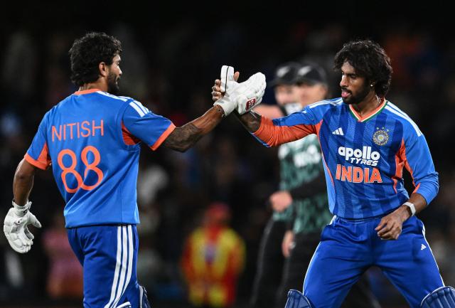 India's Tilak Varma (R) and Nitish Kumar Reddy celebrate after winning the second Twenty20 international cricket match between New Zealand and India at Hagley Oval in Christchurch on October 24, 2026. (Photo by Sanka VIDANAGAMA / AFP)