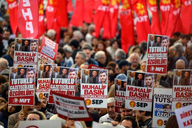 Protesters hold placard bearing portraits of journalists during a rally against what they described as growing pressure on journalists including arrests and media shutdowns, in Istanbul, on October 24, 2026. (Photo by Yasin AKGUL / AFP)