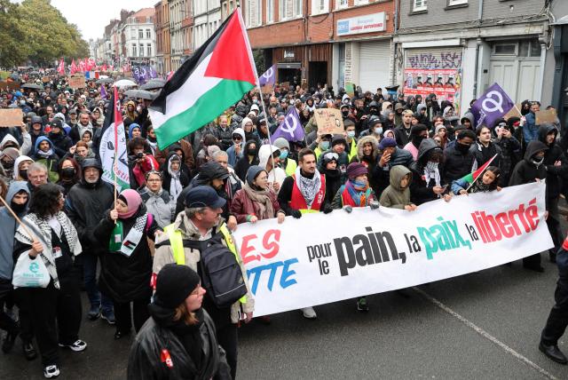 Protestors march behind a banner during a demonstration in favour of purchasing power, the protection of public services, and fiscal and social justice, in Lille, northern France on October 24, 2026, as part of a nationwide call for mobilisation bringing together former members of the Yellow Vest movement, labor unions, high school and university students. Protests by high school students over learning conditions sparked a movement that has since spread nationwide, fuelled by broader anger over the rising cost of living. About 70,000 security personnel will be deployed on October 24, 2026, Interior Minister said at a news conference, warning that calls for violence and looting were circulating on social media. (Photo by Francois LO PRESTI / AFP)