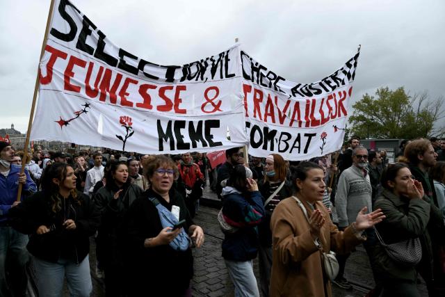 Protesters hold a banner during a demonstration in favor of purchasing power, the protection of public services, and fiscal and social justice, in Bordeaux, western France on October 24, 2026 as part of a nationwide call for mobilisation bringing together former members of the Yellow Vest movement, labor unions, high school and university students. Protests by high school students over learning conditions sparked a movement that has since spread nationwide, fuelled by broader anger over the rising cost of living. About 70,000 security personnel will be deployed on October 24, 2026, Interior Minister said at a news conference, warning that calls for violence and looting were circulating on social media. (Photo by Philippe LOPEZ / AFP)
