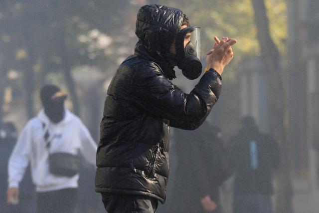 A protester gestures to riot police during a national anti-government demonstration - called by the student-led protest movement to demand better support for education and prime minister's resignation, outside the Ministry of Education in central Tirana on October 24, 2026. (Photo by Adnan Beci / AFP)