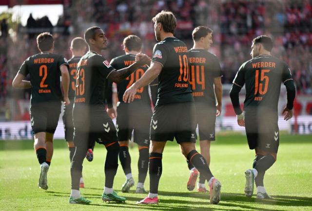 CORRECTION / Bremen's German forward #10 Niclas Fuellkrug (CR) celebrates with Bremen's Brazilian defender #13 Arthur scoring during the German first division Bundesliga football match between Mainz 05 and Werder Bremen in Mainz on October 24, 2026. (Photo by Kirill KUDRYAVTSEV / AFP) / DFL REGULATIONS PROHIBIT ANY USE OF PHOTOGRAPHS AS IMAGE SEQUENCES AND/OR QUASI-VIDEO / The erroneous mention[s] appearing in the metadata of this photo by Kirill KUDRYAVTSEV has been modified in AFP systems in the following manner: [Bremen's Brazilian defender #13 Arthur] instead of Bremen's Estonian goalkeeper #13 Karl Hein]. Please immediately remove the erroneous mention[s] from all your online services and delete it (them) from your servers. If you have been authorized by AFP to distribute it (them) to third parties, please ensure that the same actions are carried out by them. Failure to promptly comply with these instructions will entail liability on your part for any continued or post notification usage. Therefore we thank you very much for all your attention and prompt action. We are sorry for the inconvenience this notification may cause and remain at your disposal for any further information you may require.