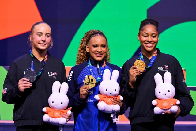 (From L) Silver medallist US' Claire Pease, gold medallist Brazil's Rebeca Andrade and bronze medallist US' Skye Blakely celebrate on the podium after the Women's Vault Final during the 54th FIG Artistic Gymnastics World Championships, in Rotterdam, southern Netherlands, on October 24, 2026. (Photo by JOHN THYS / AFP)