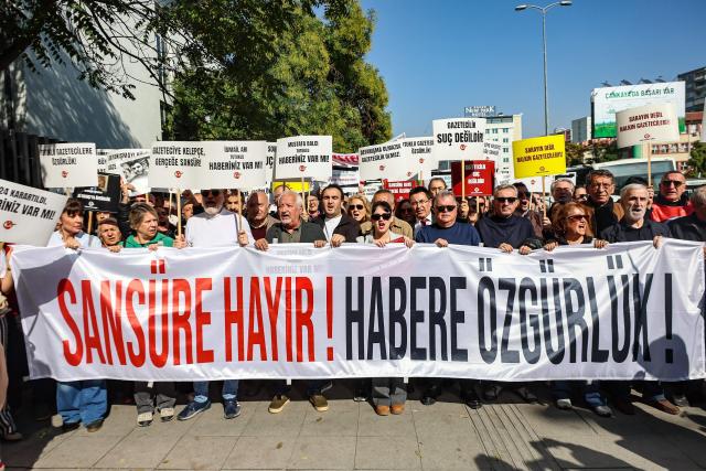 Protesters chant slogans and hold a banner reading "No to Censorship, Freedom for News" during a rally against what they described as growing pressure on journalists including arrests and media shutdowns, in Ankara, on October 24, 2026. (Photo by ADEM ALTAN / AFP)