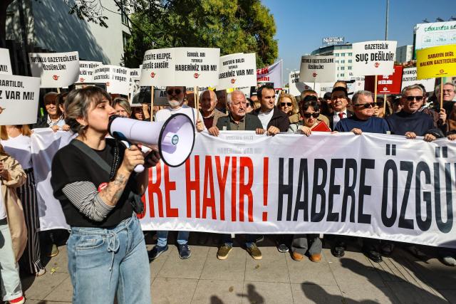 Protesters chant slogans and hold a banner reading "No to Censorship, Freedom for News" during a rally against what they described as growing pressure on journalists including arrests and media shutdowns, in Ankara, on October 24, 2026. (Photo by ADEM ALTAN / AFP)