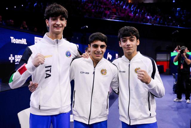(From L) Silver medallist Italy's Gabriele Targhetta, gold medallist Armenia's Hamlet Manukyan and bronze medallist Armenia's Mamikon Khachatryan celebrate after the Men's Pommel Horse Final during the 54th FIG Artistic Gymnastics World Championships, in Rotterdam, southern Netherlands, on October 24, 2026. (Photo by JOHN THYS / AFP)