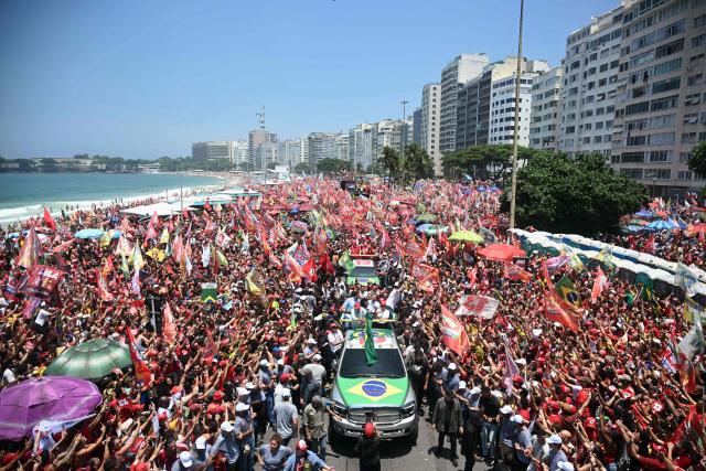 Brazil's President and presidential candidate Luiz Inacio Lula da Silva (C, left) of the Workers' Party (PT) attends a rally on Copacabana beach in Rio de Janeiro, Brazil, on October 24, 2026, ahead of the presidential election runoff. (Photo by MAURO PIMENTEL / AFP)